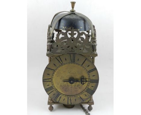 A mid 18th century and later lantern clock, dial marked P Hindle of Norfolk. with pierced and foliate decoration above a chap