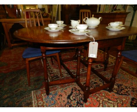 A 20th century oak gate-leg table, raised on bobbin feet and joined by stretchers.