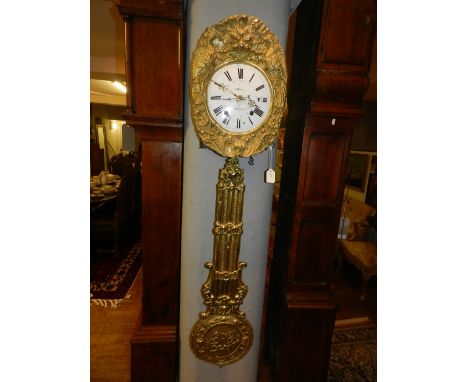 A 19th century French eight day striking comtoise wall clock, having highly ornate chaised face and pendulum, the white ename