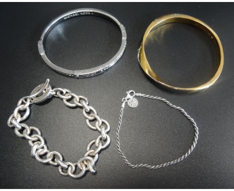 THREE FASHION BRACELETScomprising a Michael Kors Logo plaque and crystal set silver tone bangle, a Links of London silver bra