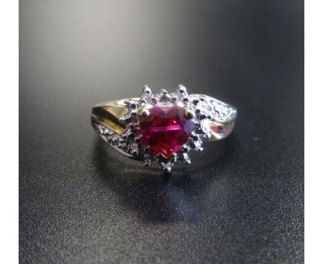 SYNTHETIC RUBY AND DIAMOND CLUSTER DRESS RINGthe central heart cut ruby in textured surround set with small diamonds, on nine