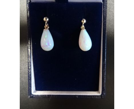 PAIR OF OPAL DROP EARRINGSthe teardrop shaped opals in gold mounts 