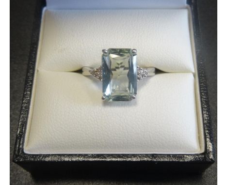 AQUAMARINE AND DIAMOND DRESS RINGthe central radiant cut aquamarine approximately 3.2cts, flanked by six diamonds to each sho