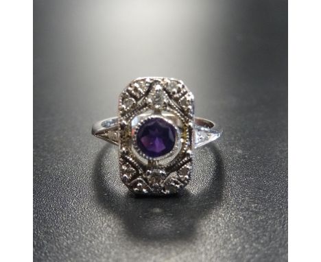 ART DECO STYLE AMETHYST AND DIAMOND PLAQUE RINGthe central round cut amethyst in diamond set surround, on nine carat gold sha