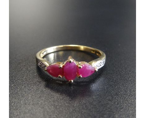 RUBY AND DIAMOND RINGthe central marquise cut ruby flanked by pear cut rubies and small diamonds, on nine carat gold shank, r