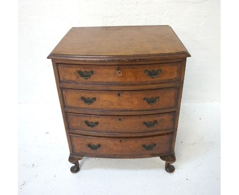 BURR WALNUT BOW FRONT CHESTof four drawers, raised on short cabriole legs, 73.5cm high x 60cm wide. with key 