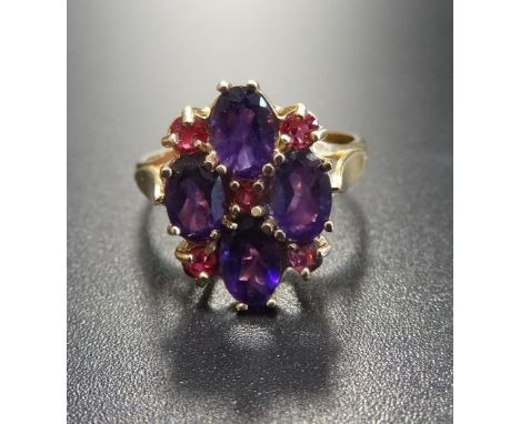 RUBY AND AMETHYST DRESS RINGthe four oval amethysts separated by small rubies, on nine carat gold shank, ring size N-O 