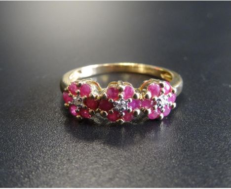 RUBY AND DIAMOND TRIPLE CLUSTER RINGeach of the three small diamonds in six ruby surround, on nine carat gold shank, ring siz