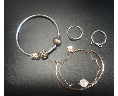 PANDORA AND SWAROVSKI JEWELLERYcomprising a Pandora Rose clasp bangle with two Rose charms, one set with CZ; a Pandora Radian