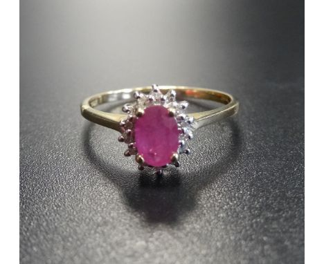 RUBY AND DIAMOND CLUSTER RINGthe central oval cut ruby in diamond surround, on nine carat gold shank, ring size O-P 