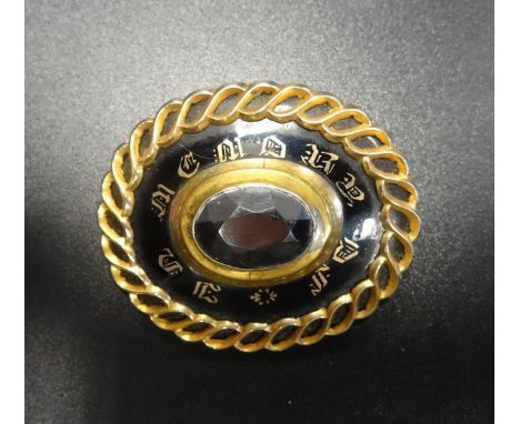 VICTORIAN MOURNING BROOCHthe central stone surrounded by black enamel with the words 'In Memory of', in unmarked gold mount, 