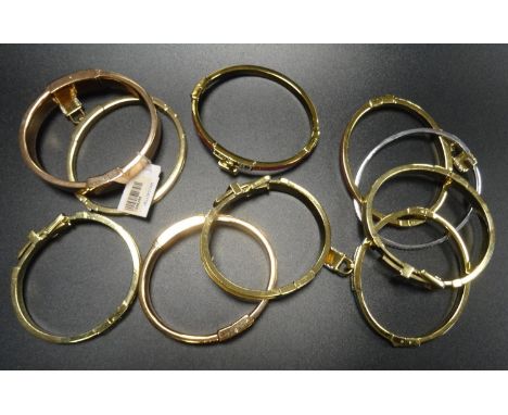 NINE MICHAEL KORS BANGLEScomprising three enamel and pave crystal set padlock bangles (turquoise, orange and pink), and anoth
