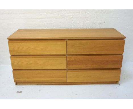MODERN LIGHT OAK CHESTwith an arrangement of six drawers with recessed lip handles, standing on a plinth base, 160.5cm wide 