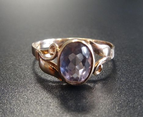 AMETHYST SINGLE STONE RINGthe oval cut amethyst flanked by pierced scroll decorated shoulders, on nine carat gold shank, ring