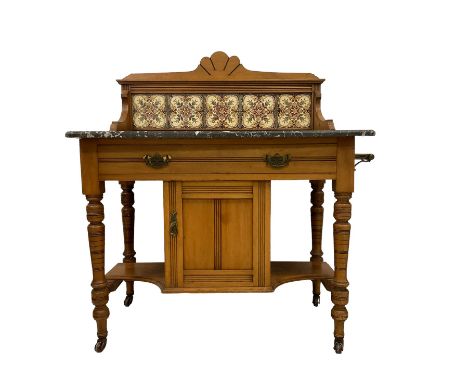 Late Victorian walnut framed washstand, raised back with scallop pediment over five tiles with flower head decoration, the re