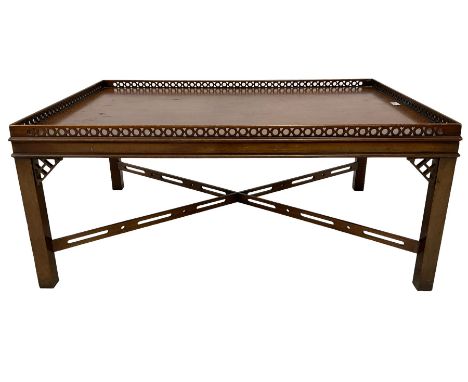 Chippendale design mahogany coffee table, rectangular top with pierced fretwork gallery, on square supports united by pierced