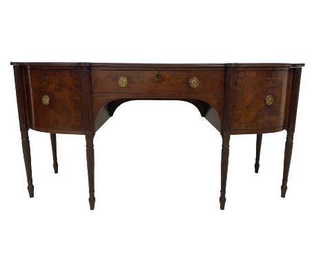 George III mahogany bow front sideboard, the shaped top with reeded edge, fitted with central frieze drawer, the bookmatched 