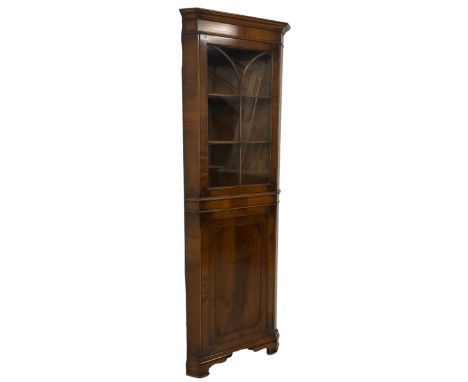 Georgian design mahogany corner display cabinet, moulded cornice over plain frieze, the upper section enclosed by astragal gl