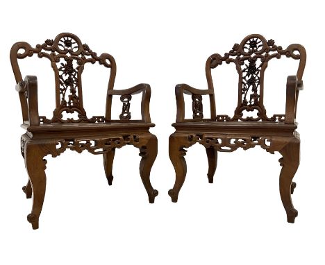 Pair Chinese carved hardwood armchairs, the cresting rail and centre splat pierced and carved with roses and scrolling decora