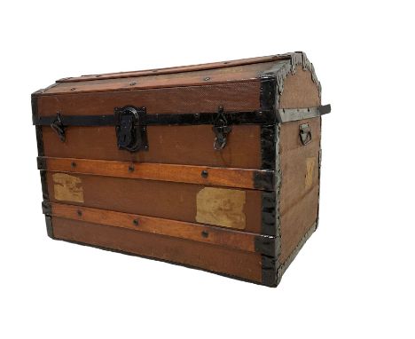 Early 20th century travelling trunk, hinged dome top with iron fittings, wood bound, on castorsDimensions: Height:&nbsp;53cm&