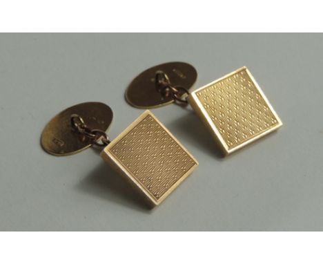 A pair of 9 carat gold cufflinks, the oval back panels to engine turned square panels which are unmarked but test as gold, 10