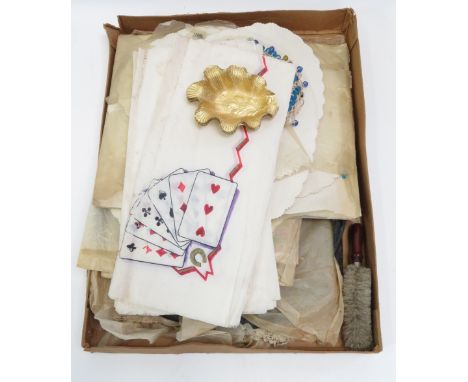 A quantity of early 20th Century printed paper tray and tablecloths, some with playing card motifs; plain paper doilies; moul