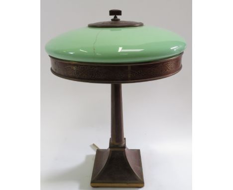 A circa 1920's table lamp of brass inlaid wood veneer, having opaque light green glass shade, tapering wood and brass column 