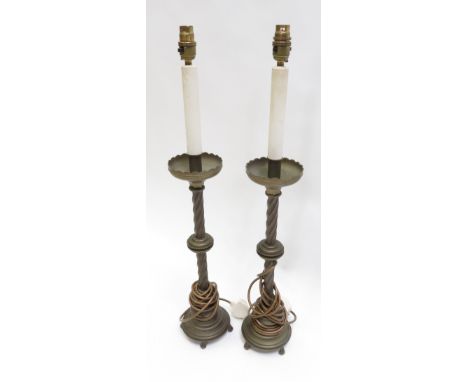 A pair of 20th Century decorative brass table lamps in the form of tall candle holders with spiral twist pillar on stepped ci