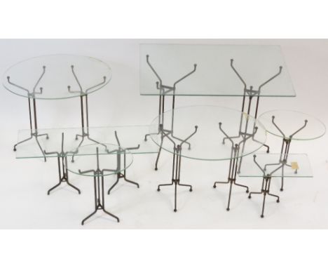 Eleven early 20th Century tubular metal shop display stands of tripod form, various sizes, the tallest 61cm high, with variou