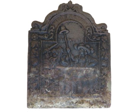 An antique cast iron fire back of arched shape and cast with man holding a hat on a long stick, 72cm high max, 54cm wide