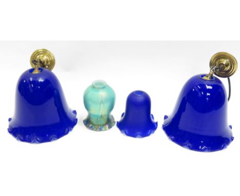 A pair of modern blue and white glass ceiling light shades of harebell design, with brass ceiling roses and fittings together