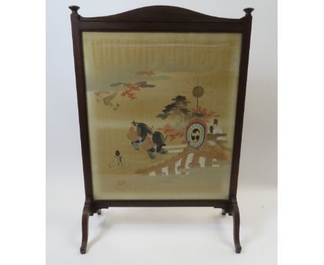 An early 20th Century mahogany framed firescreen having central Japanese painted silk panel decorated with Samurai and other 