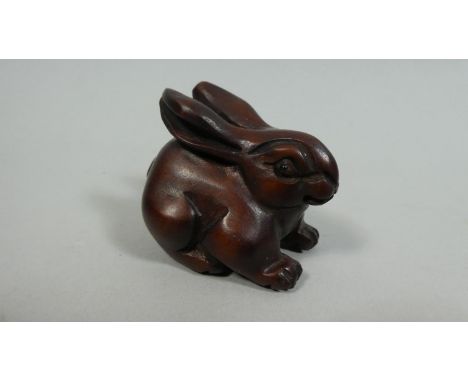 A Carved Wood Netsuke in the form of a Portly Recumbent Rabbit, 4.5cm High 