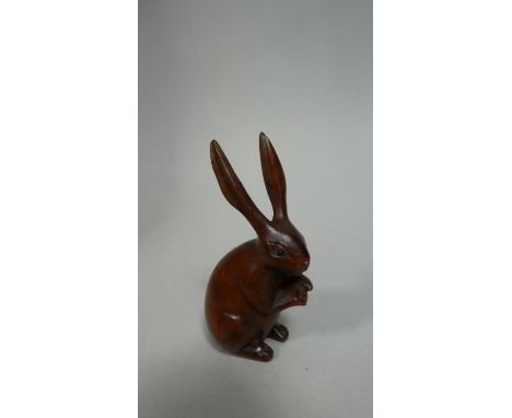 A Wooden Carved Netsuke in the Form of a Sitting Hare, 7cm high