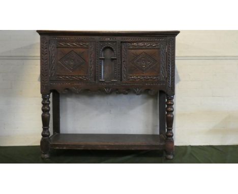 A 19th Century Carved Oak Cheese Cupboard with Panelled Doors and Stretcher Shelf to Turned Supports, 112cm Wide 