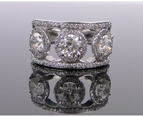 A large platinum 3 stone diamond cluster ring,modern round brilliant-cut stones, total diamond content approx. 3.4cts, larger