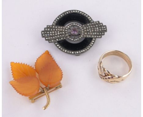 A 14ct gold ruby and diamond set knot ring,13g, an Art Deco marcasite and silver brooch and a leaf design brooch, (3).