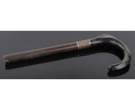 A 19th century carved rhino horn parasol handle,with gold plated collar. According to CITES regulations this item dates to pr