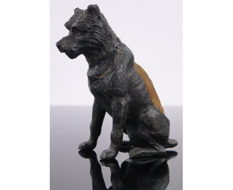 A Victorian patinated metal dog pin cushion,height 55mm.