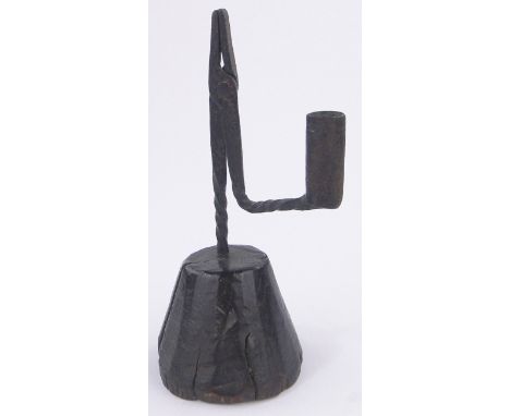 An Antique wrought-iron rush light holder on wooden stand,overall height 22.5cm.