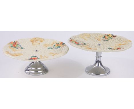 A pair of Clarice Cliff Barbola pattern comports,with embossed fruit designs on chrome bases, diameter 22cm.
