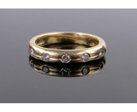 An 18ct gold 5 stone diamond band ring,size K, 4.5g.