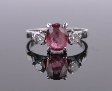 An 18ct white gold ruby and diamond 3 stone ring,total diamond content approx. 0.35cts, ruby height 8mm, size O.