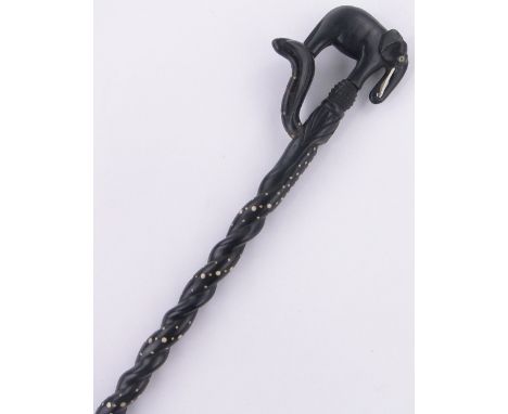 An Indian carved ebony and ivory inlaid elephant design walking stick.