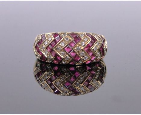 An 18ct gold ruby and diamond set zigzag design band ring,band width 9mm, size M.