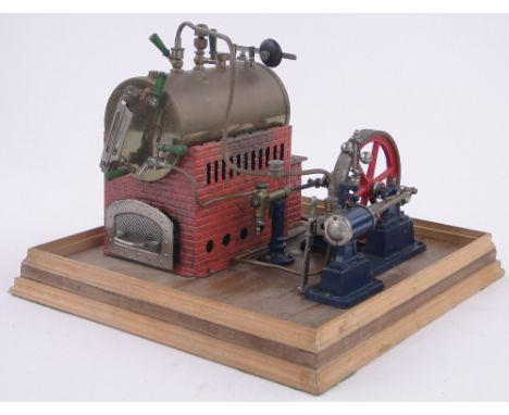 A Bing live steam powered stationary engine,stamped GBN, on wooden plinth base, plinth length 30cm.