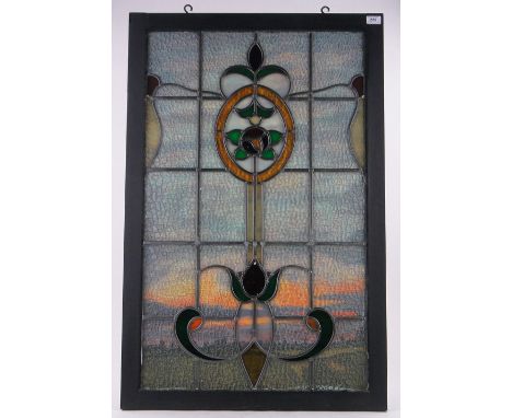 A stained glass lead light panel,framed with painted landscape panel behind, overall dimensions 103cm x 67cm.