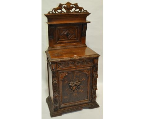 A Victorian carved oak side cabinet,with a raised and carved shelf panelled back, single frieze drawer and cupboard door unde