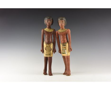 20th century AD. A pair of wooden and painted figures of striding males with painted dark brown bodies; black bag wigs to the