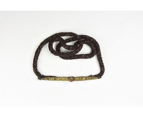 Early 20th century AD. A remade twisted leather belt with early 20th century buckles, each with applied gilded filigree scrol